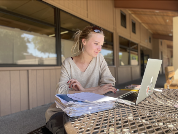 Paly senior Natalia Hopper, who committed to USC despite the high tuition, looks over her Schoology during her free period. 
